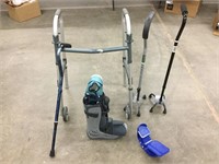 Two quad canes, one regular cane, a boot, foot