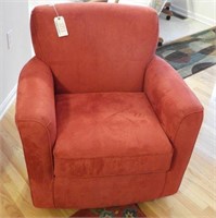Red upholstered chair with rotating base