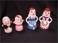 Four sets of egg cups in the form of people; head