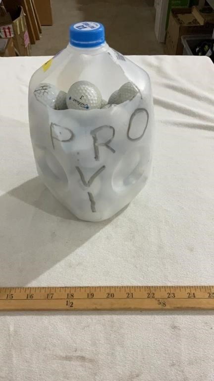 Milk jug full of golf balls