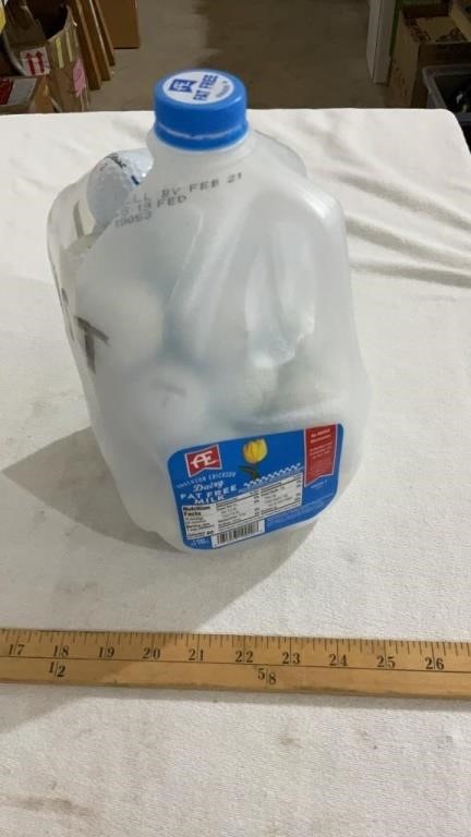 Milk jug full of golf balls