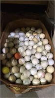 A box of used golf balls full to the top