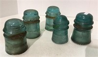 A lot of five vintage glass insulators -three from