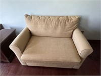 Tan upholstered love seat