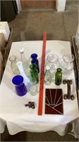 Glass vases, glass bottles, decorative rocks