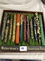 Antique fountain pens and pencils in a wooden