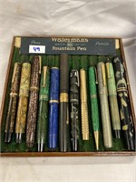 Antique fountain pens and pencils in a wooden pen