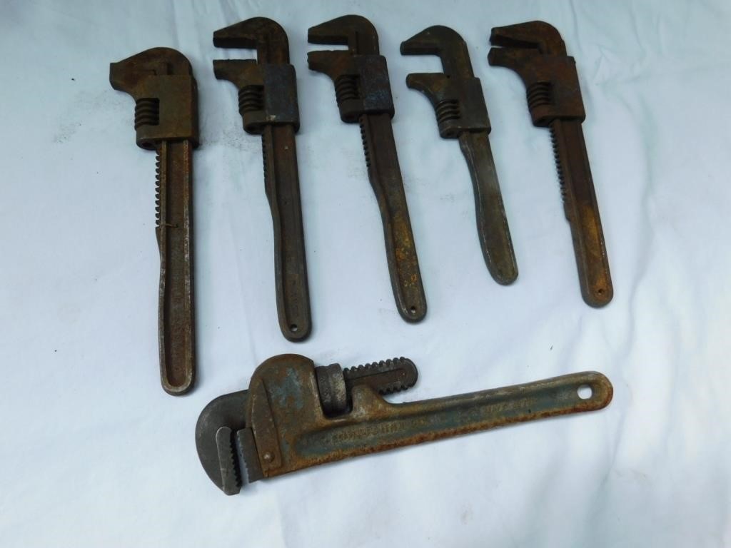 Six vintage pipe wrenches.