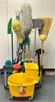 Mops, brooms, bucket, and storage rack