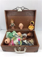 small case of dolls, parts, disguises