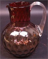 A 8 1/2" ruby-to-smoke coinspot pitcher with