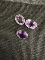 Trio of faceted oval cut amethyst stones,