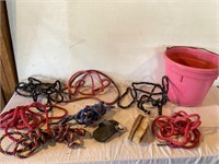 Rope halters and a pink feed bucket