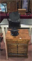 Antique printing press with printer cabinet