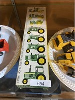 eight John Deere Manor toy tractors in boxes