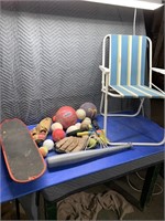 Folding chair, small skateboard, several kids