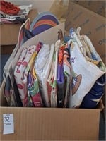 Box of various table cloths and window clings