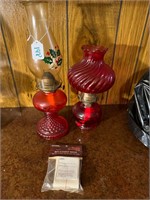 2 red glass oil lamps & extra bag of wicks