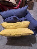 Tote full of yellow and blue pillows. Total of 9