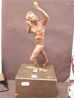 Metal statue of a young boy playing with rope,