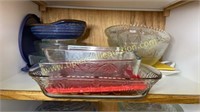 Shelf of Pyrex baking dishes and glass bowls and