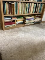 Bottom two shelves of books bring boxes