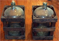 2 glass jugs both in wooden crates. 1 is "Glen