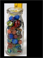 POT. MILK BOTTLE OF MARBLES - BOTTLE W/ HOLE-SIDE