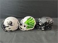 Three U of O Mini Helmets