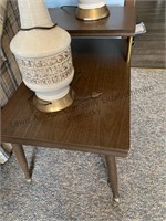 End table and two lamps. One has a shade the