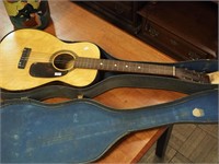 Six-string acoustic guitar with case