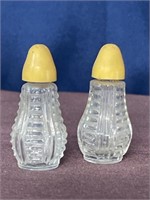 Clear glass salt & pepper shakers yellow plastic