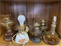 Six assorted lamps, and Amber candle stick holder