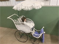 Antique wicker baby buggy with doll
