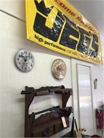 Wooden gun rack and items on wall