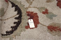 Large red, tan, and brown designed rug