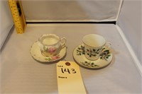 2 small tea cups and plates