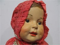 Antique doll in red outfit