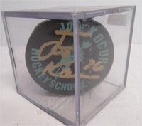 Autographed Joe Kocur hockey puck with display