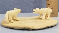 Fossilized ivory carvings of a pair of wolves, mou
