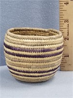 Tightly woven grass "cup", with dyed grass design,