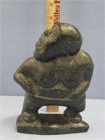 Black soapstone carving of a dancing man, signed S