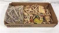 Box full of mostly wood clothes pins