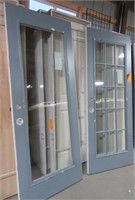 Pair of new entry French doors with glass panels.