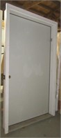 Large heavy entry door with jamb and threshold.