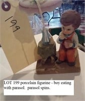 figurine boy eating from cup, parasol spins