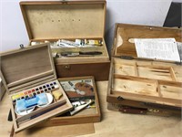 Five artist boxes with content