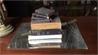Stack of old bibles on mirrored tray