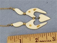 Abstract ivory pendent, has 4 small gold nuggets,