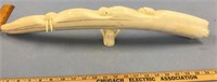 Large fossilized walrus tusk carved by Dennis Pung